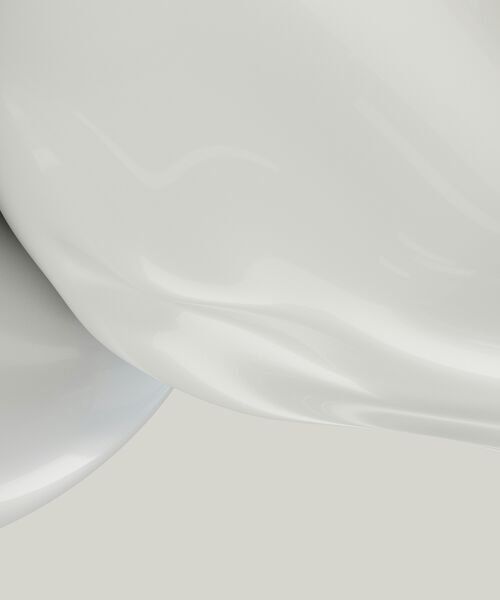 Abstrakte Nahaufnahme einer glänzenden, weißen Oberfläche mit weichen Lichtreflexen.